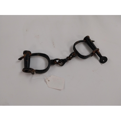 63 - Pair of RIC handcuffs. {28 cm L}.