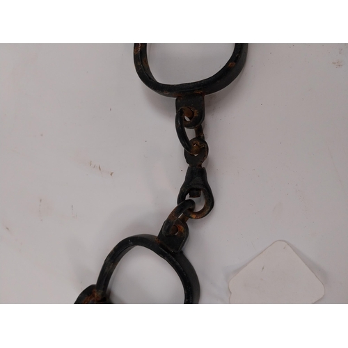 63 - Pair of RIC handcuffs. {28 cm L}.