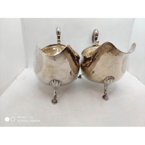 444 - Pair of George III Irish silver sauce boats, plain oval form, leaf capped scroll handles, on three s... 