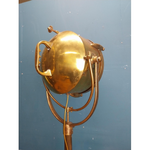 57 - Early 20th C. brass search light on cast iron base. {186 cm H x 50 cm W x 50 cm D].