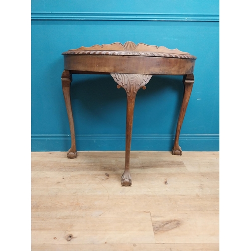 85 - 1950's mahogany demi lune table with carved frieze on the claw and ball feet. {83 cm H x 90 cm W x 4... 