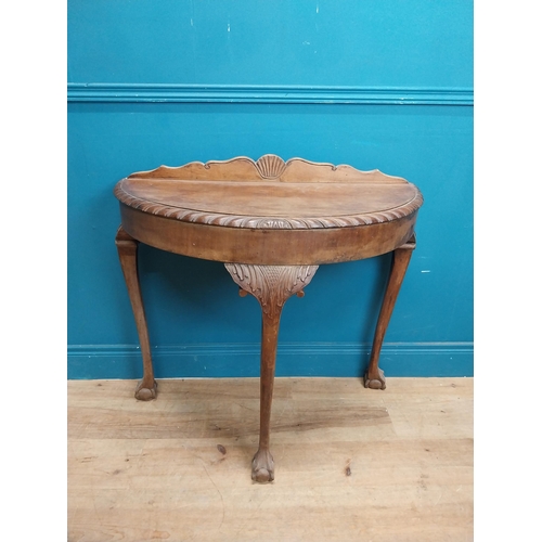 85 - 1950's mahogany demi lune table with carved frieze on the claw and ball feet. {83 cm H x 90 cm W x 4... 