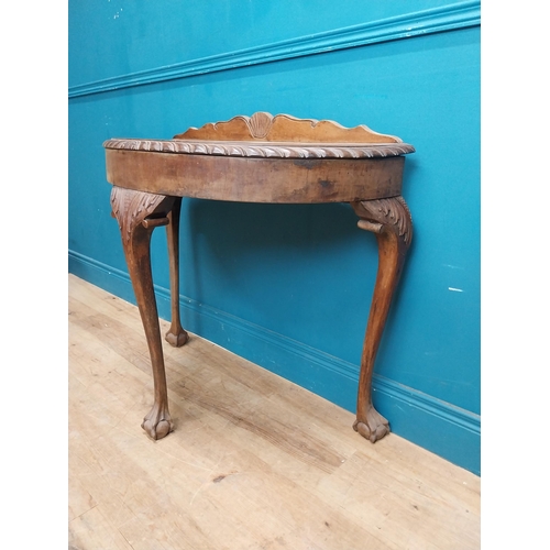 85 - 1950's mahogany demi lune table with carved frieze on the claw and ball feet. {83 cm H x 90 cm W x 4... 