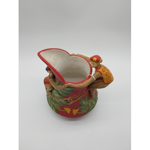 852 - Early 20th C. ceramic jug with monkey handle decoration. {26 cm H x 23 cm W x 18 cm D}.