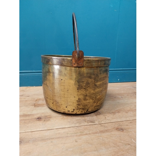 900 - Early 20th C. brass log bucket with wrought iron handle {52 cm H x 47 cm Dia.}.