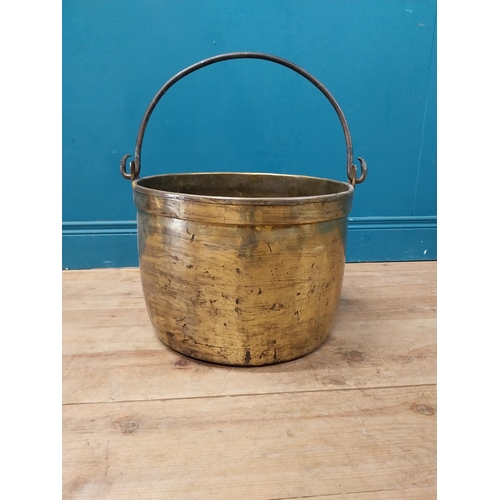 900 - Early 20th C. brass log bucket with wrought iron handle {52 cm H x 47 cm Dia.}.