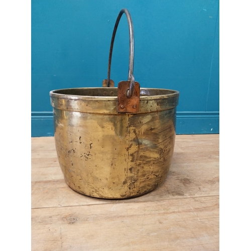 900 - Early 20th C. brass log bucket with wrought iron handle {52 cm H x 47 cm Dia.}.