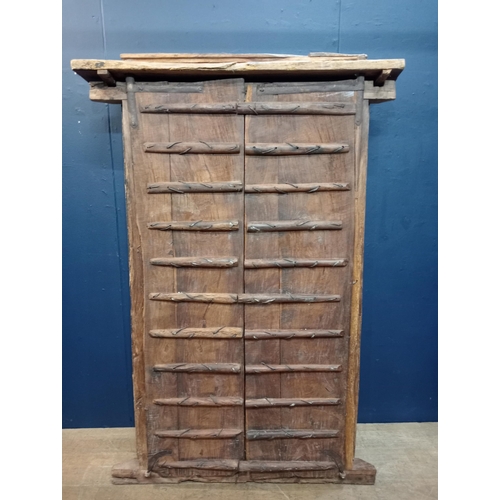 902 - Wooden temple door heavy carved with metal panels and studding {H 180cm x W 120cm x D 40cm }. { not ... 