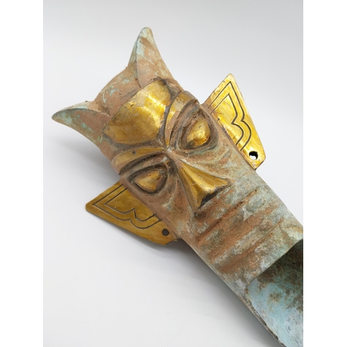 903 - Gilded bronze Tribal mask. {42 cm H x 22 cm W x 14 cm D}.