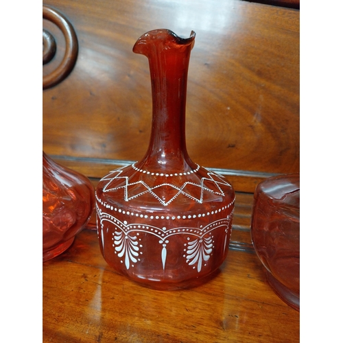 919 - Four 19th C. ruby glass jugs. {22 cm H}.