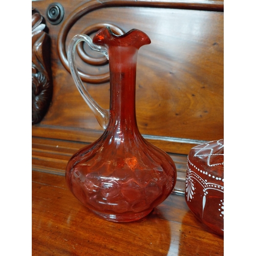 919 - Four 19th C. ruby glass jugs. {22 cm H}.