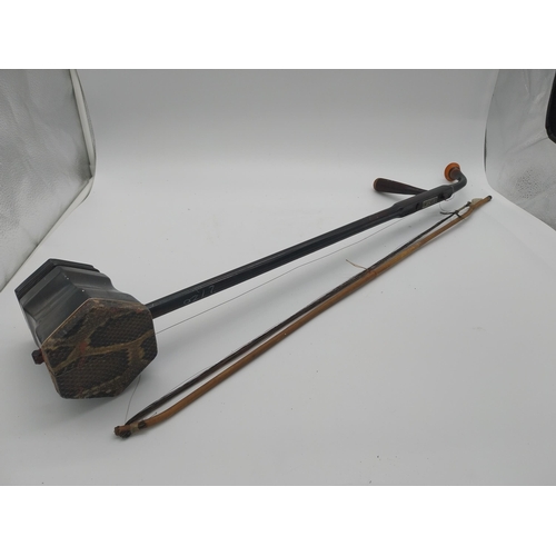 935 - Xinghai Chinese violin and bow. {82 cm L x 13 cm W x 10 cm D}.