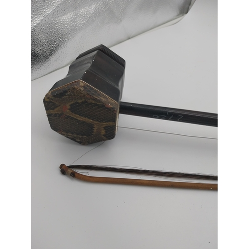 935 - Xinghai Chinese violin and bow. {82 cm L x 13 cm W x 10 cm D}.