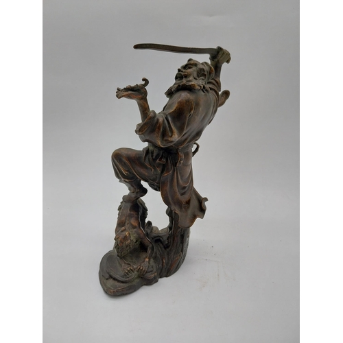 938 - Bronze model of Oriental warrior. {26 cm H x 19 cm W x 12 cm D}.