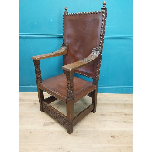 947 - Edwardian carved oak and leather upholstered throne chair. {165 cm H x 63 cm W x 55 cm D}.