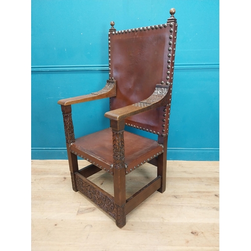 947 - Edwardian carved oak and leather upholstered throne chair. {165 cm H x 63 cm W x 55 cm D}.