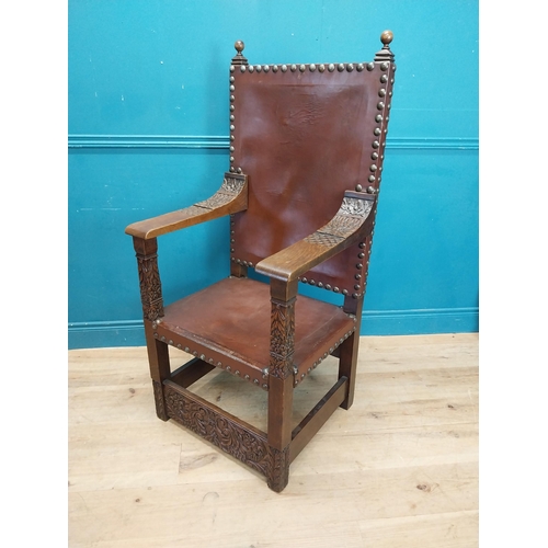 947 - Edwardian carved oak and leather upholstered throne chair. {165 cm H x 63 cm W x 55 cm D}.