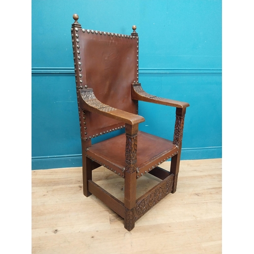 947 - Edwardian carved oak and leather upholstered throne chair. {165 cm H x 63 cm W x 55 cm D}.