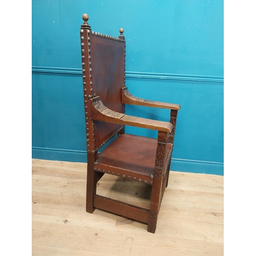 947 - Edwardian carved oak and leather upholstered throne chair. {165 cm H x 63 cm W x 55 cm D}.