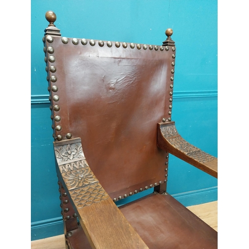 947 - Edwardian carved oak and leather upholstered throne chair. {165 cm H x 63 cm W x 55 cm D}.