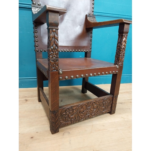 947 - Edwardian carved oak and leather upholstered throne chair. {165 cm H x 63 cm W x 55 cm D}.