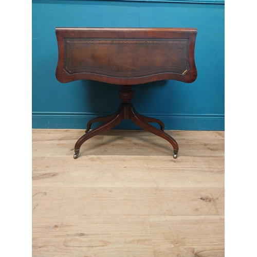 973 - Walnut drop leaf centre table with leather top raised on carved column, four outswept feet and casto... 