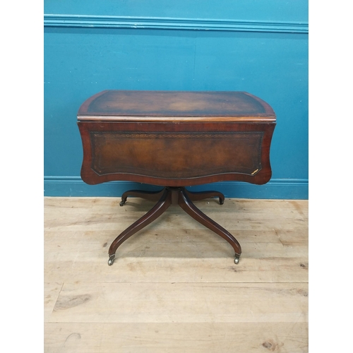 973 - Walnut drop leaf centre table with leather top raised on carved column, four outswept feet and casto... 