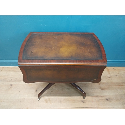 973 - Walnut drop leaf centre table with leather top raised on carved column, four outswept feet and casto... 