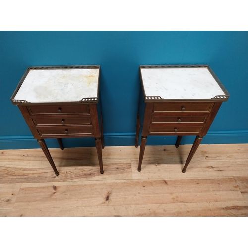 977 - Pair of 19th C. mahogany and brass bedside lockers with inset marble top and three drawers raised on... 