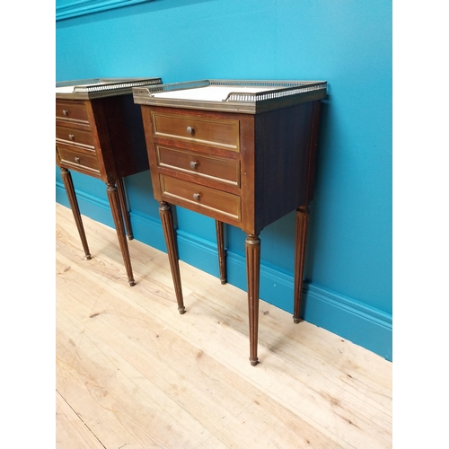 977 - Pair of 19th C. mahogany and brass bedside lockers with inset marble top and three drawers raised on... 