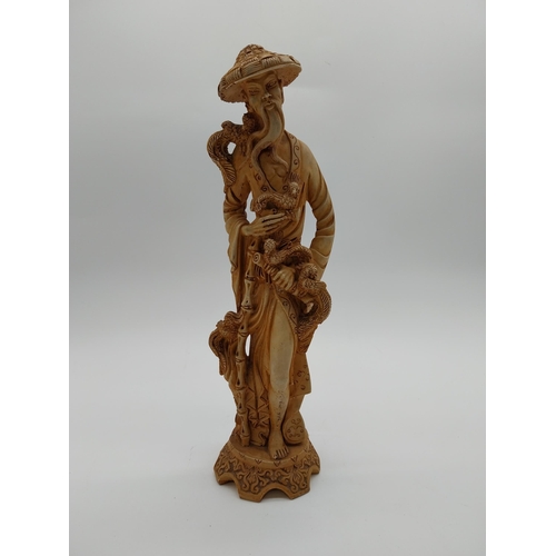 981 - Resin oriental figure of a Man. {37 cm H x 12 cm W x 11 cm D}.