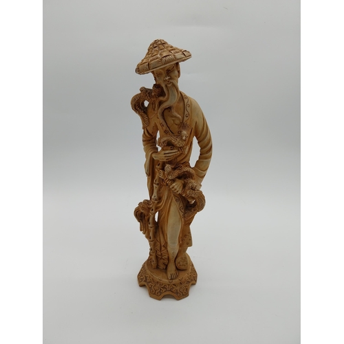 981 - Resin oriental figure of a Man. {37 cm H x 12 cm W x 11 cm D}.