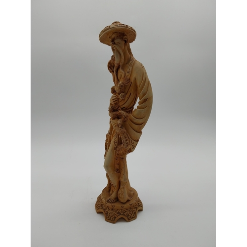 981 - Resin oriental figure of a Man. {37 cm H x 12 cm W x 11 cm D}.