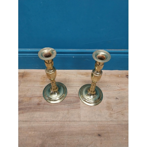 991 - Pair of brass candle sticks {27 cm H x 13 cm Dia.}.