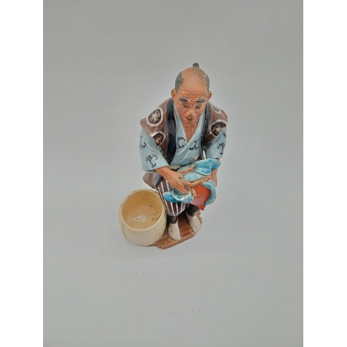 998 - Glazed stoneware Oriental figure of a Fruit Picker. {23 cm H x 14 cm D x 9 cm D}.