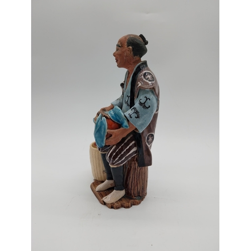 998 - Glazed stoneware Oriental figure of a Fruit Picker. {23 cm H x 14 cm D x 9 cm D}.