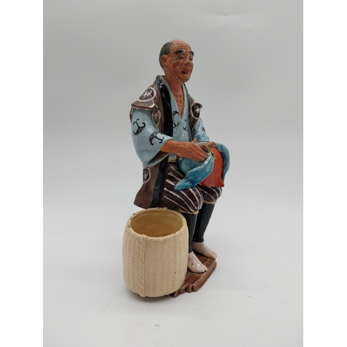 998 - Glazed stoneware Oriental figure of a Fruit Picker. {23 cm H x 14 cm D x 9 cm D}.