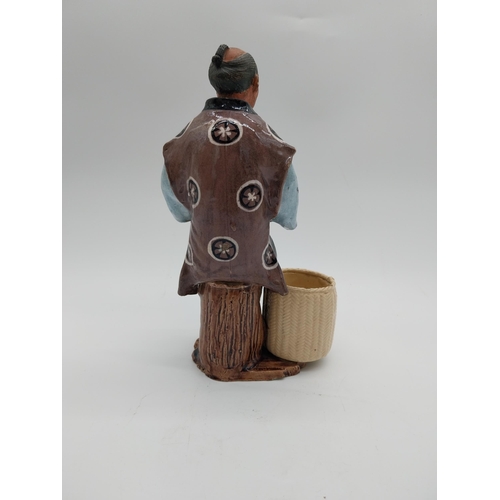 998 - Glazed stoneware Oriental figure of a Fruit Picker. {23 cm H x 14 cm D x 9 cm D}.