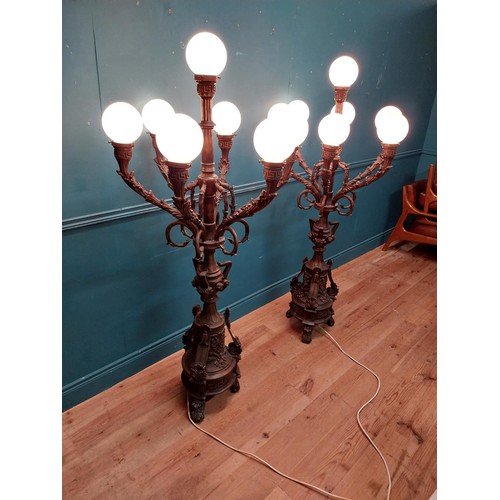 1002 - Pair of decorative bronze floor candelabras with opaline glass shades {174 cm H x 75 cm Dia.}.