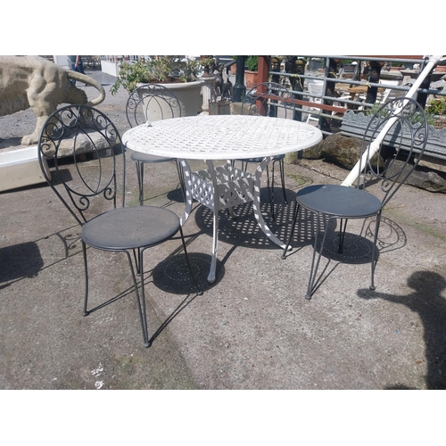 1018 - Cast iron aluminium garden table and four wrought iron garden chairs {Tbl. 73 cm H x 106 cm Dia. and... 