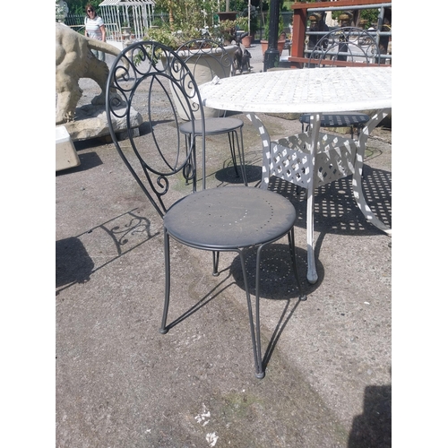 1018 - Cast iron aluminium garden table and four wrought iron garden chairs {Tbl. 73 cm H x 106 cm Dia. and... 