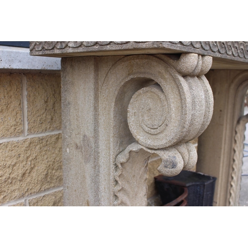 115 - Sandstone chimney piece with scroll and corbel design{H 120cm x W 140cm x D 45cm }.