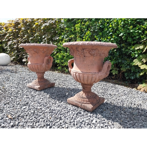 13 - Pair of moulded terracotta lattice urns ivy leaf decoration {56 cm H x 46 cm Dia.}.