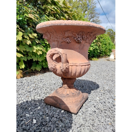 13 - Pair of moulded terracotta lattice urns ivy leaf decoration {56 cm H x 46 cm Dia.}.