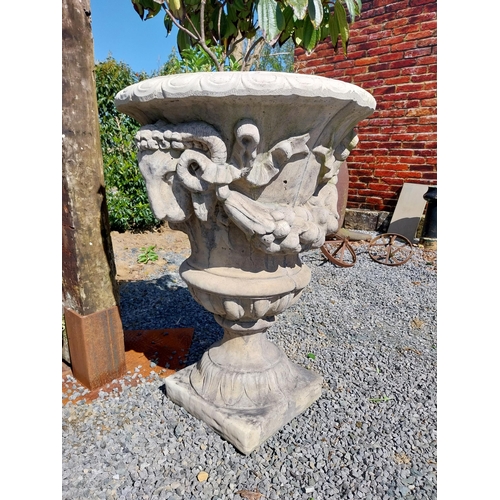 132 - Pair of moulded stone urns decorated with rams heads {104 cm H x 74 cm Dia.}.