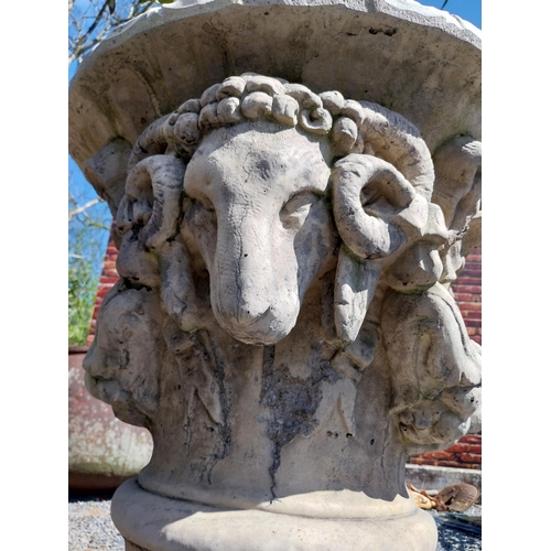 132 - Pair of moulded stone urns decorated with rams heads {104 cm H x 74 cm Dia.}.