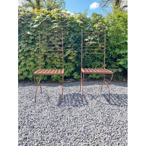 154 - Pair of wrought iron high back garden chairs {114 cm H x 44 cm W x 44 cm D}.