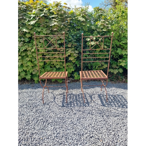 154 - Pair of wrought iron high back garden chairs {114 cm H x 44 cm W x 44 cm D}.