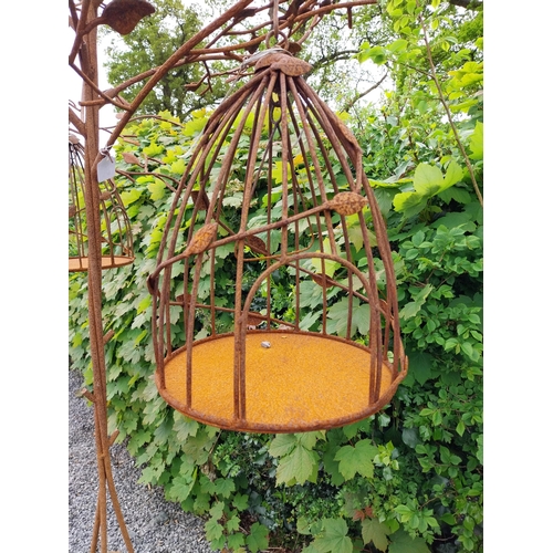 160 - Decorative wrought iron bird feeder in the form of a tree and two hanging bird cages {224 cm H x 135... 