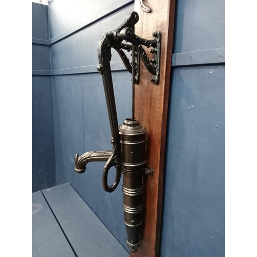 171 - Ornate cast iron water pump mounted on wooden board{H 133cm x W 36cm x D 41cm }. (NOT AVAILABLE TO V... 